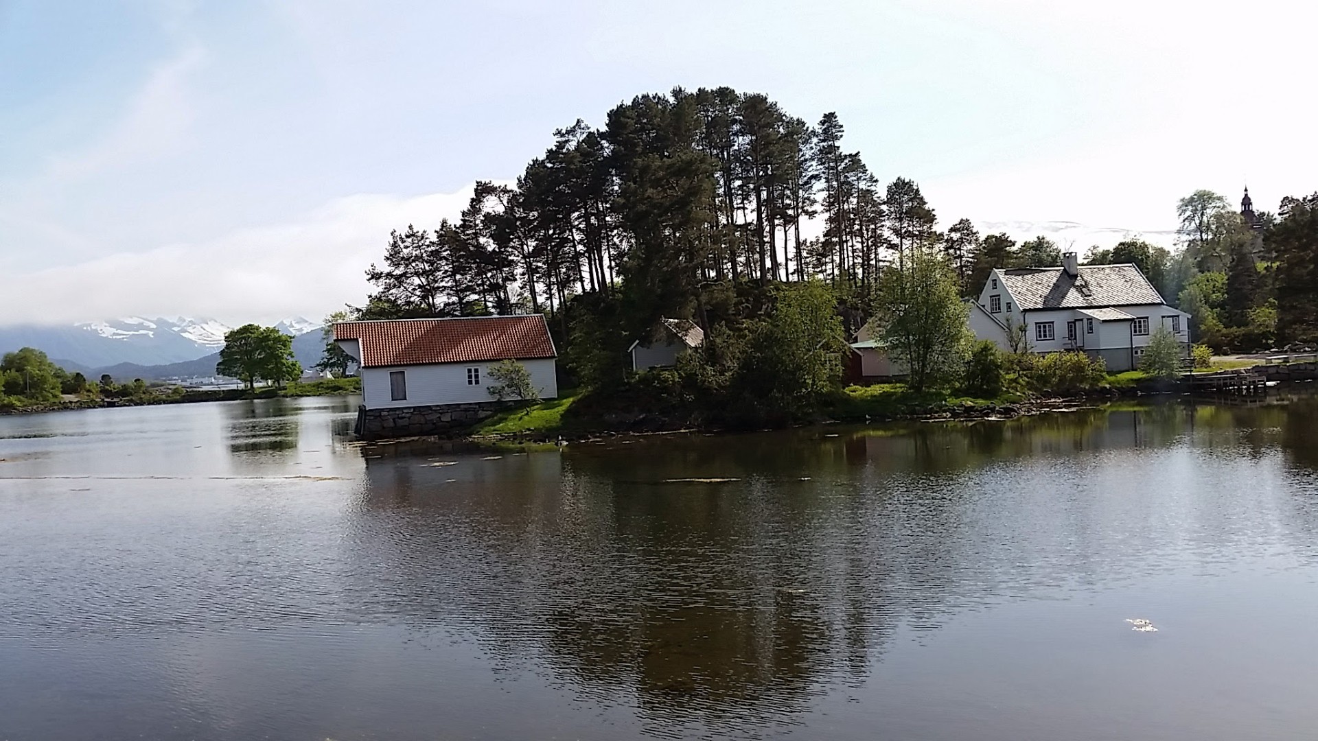 View across the water toward the old buildings at Borgundgavlen